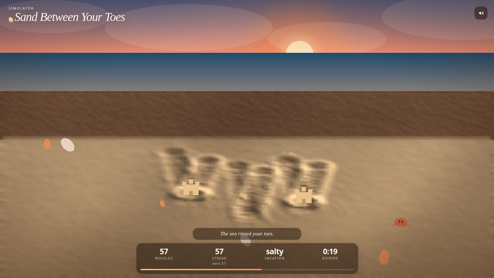 Desktop view of the golden-hour beach, with toe tracks in the sand, shells, a crab, and a sunset over the water